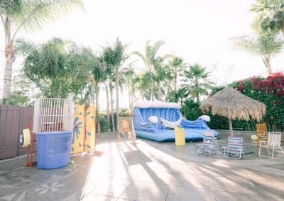 A dunk take and a water inflatable at a tropical outdoor party