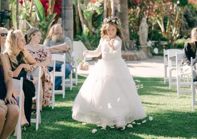 a young flower girl walks down the aisle during an outdoor wedding ceremony in Moorpark, CA