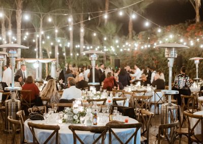 an outdoor wedding reception at night, lit up by string lights at a wedding venue in Moorpark